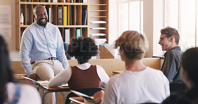 Buy stock photo Shot of mature man teaching a class of teenage students