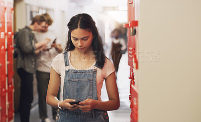 Buy stock photo High school, student and hallway with cellphone texting by lockers for education, scholarship or communication. Girl, smartphone and building corridor for academic learning or campus, course or app