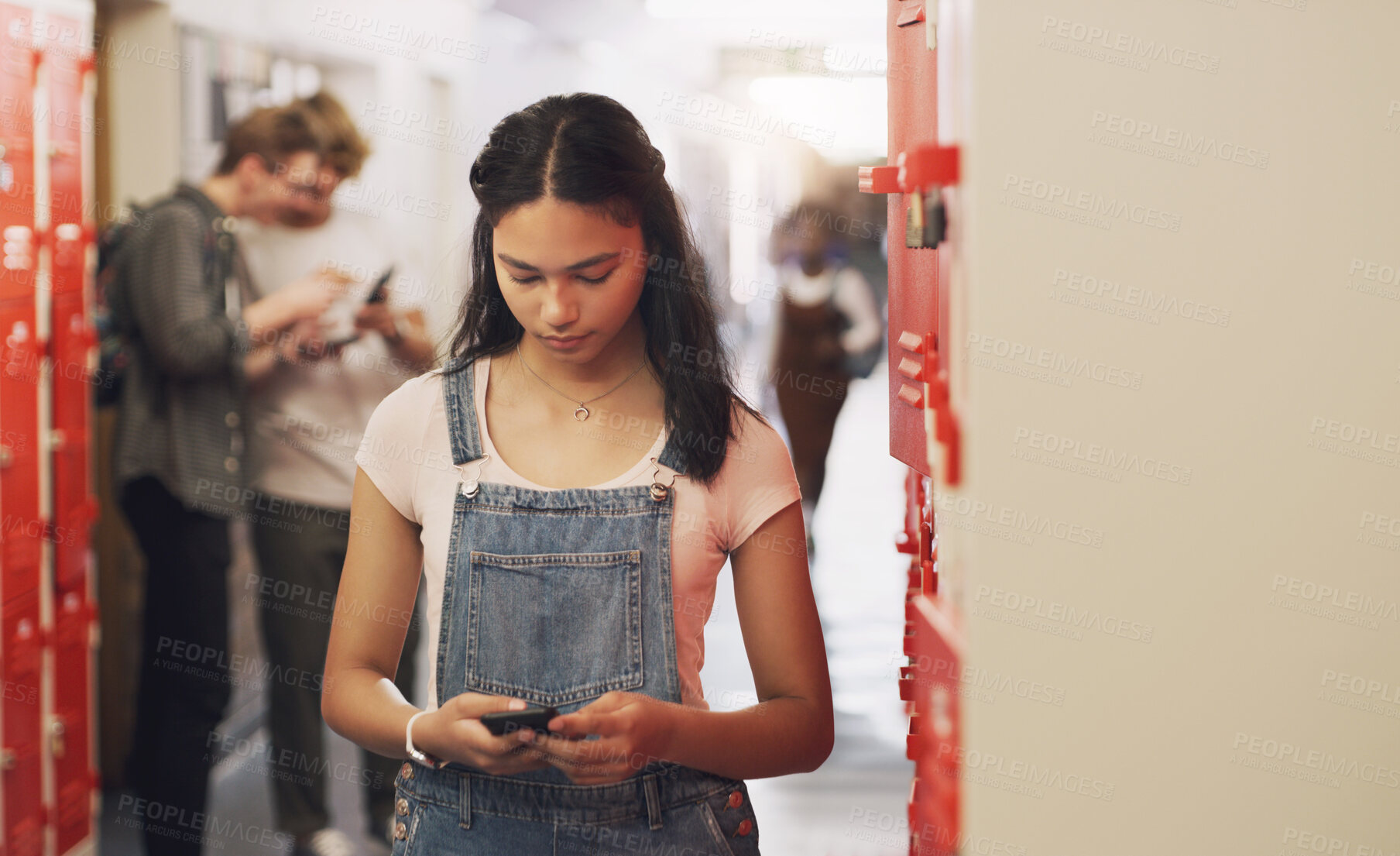 Buy stock photo High school, student and hallway with cellphone texting by lockers for education, scholarship or communication. Girl, smartphone and building corridor for academic learning or campus, course or app