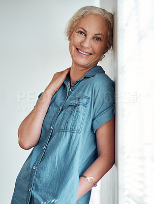Buy stock photo Portrait of an attractive mature woman leaning against a wall at home
