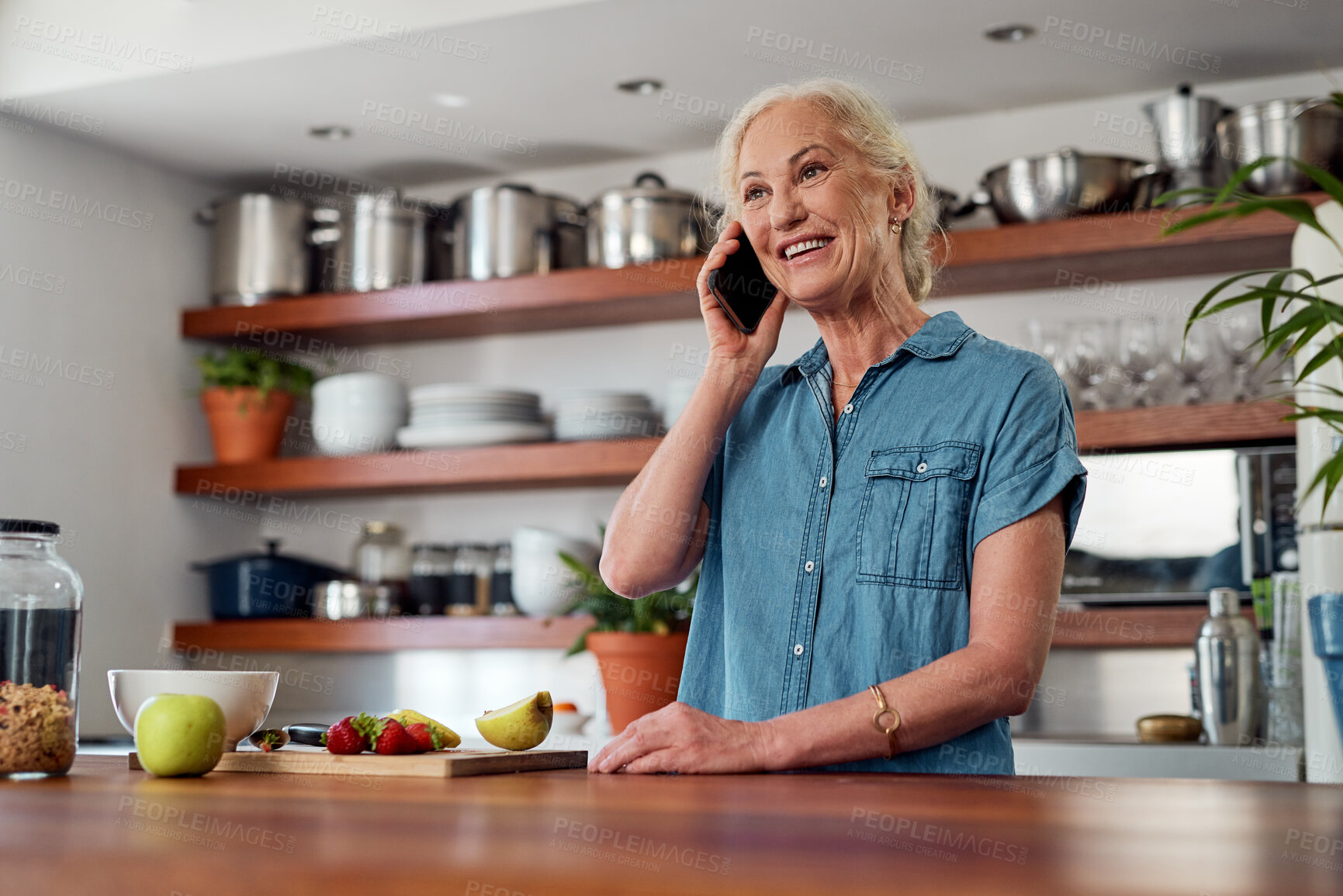 Buy stock photo Mature woman, kitchen and phone call for discussion, cooking and conversation. Fruit, morning and communication with friend on cellphone for breakfast smoothie ingredients or recipe for meal in home