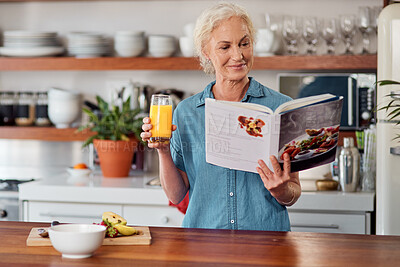Buy stock photo Shot of a mature woman reading a book while preparing breakfast at home