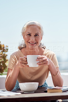 Buy stock photo Portrait of a mature woman having coffee with her breakfast on the balcony at home