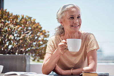 Buy stock photo Shot of a mature woman having coffee on the balcony at home