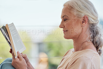 Buy stock photo Shot of a mature woman reading a book on her balcony at home