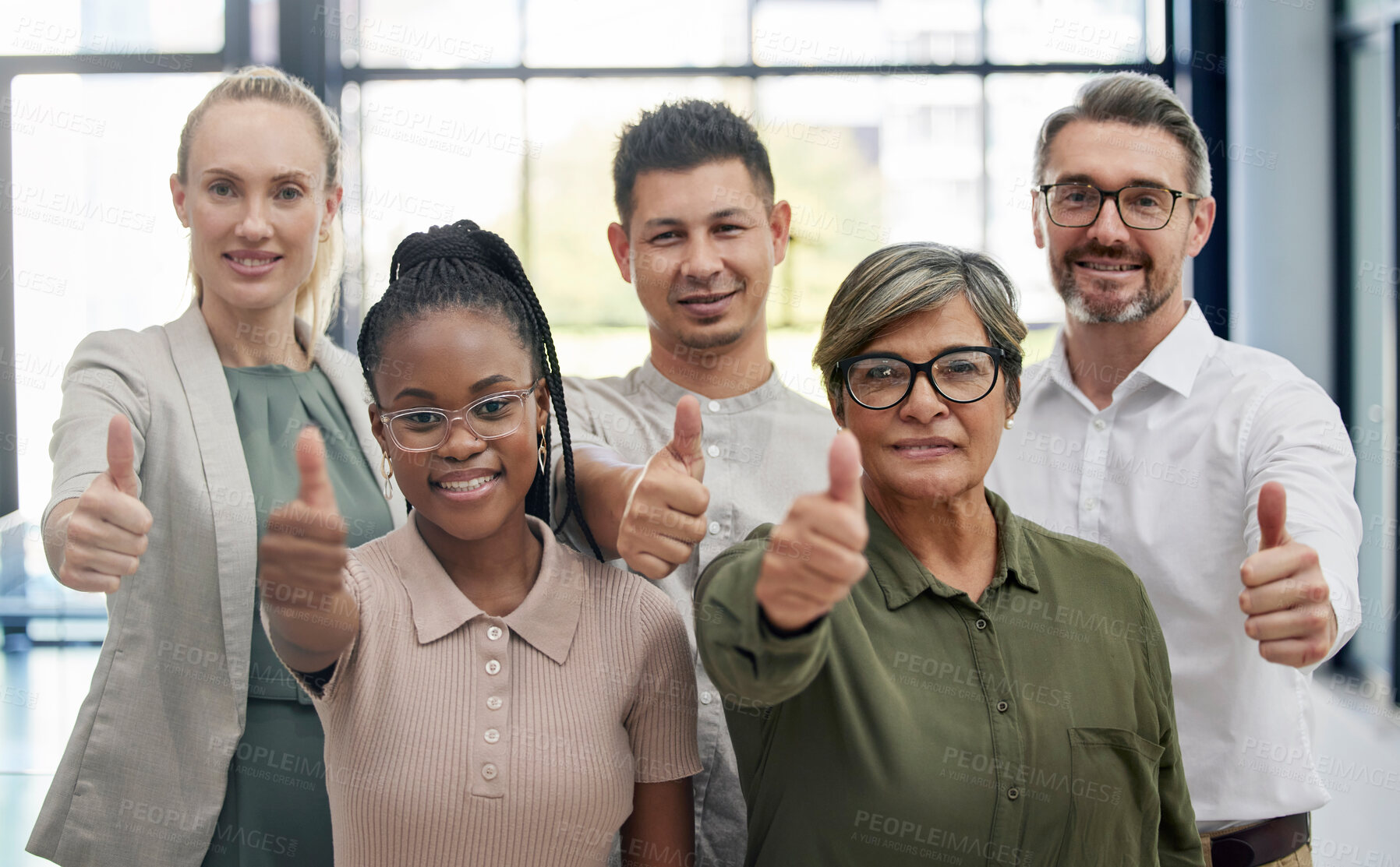 Buy stock photo Shot of a diverse group of businesspeople giving the thumbs up