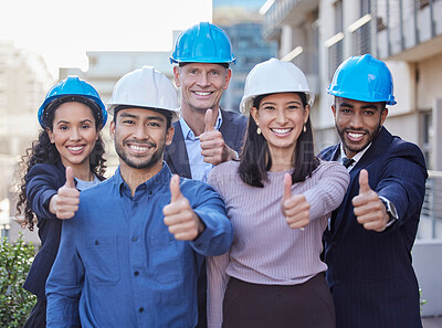 Buy stock photo Shot of a diverse group of businesspeople standing together and showing a thumbs up while wearing hardhats