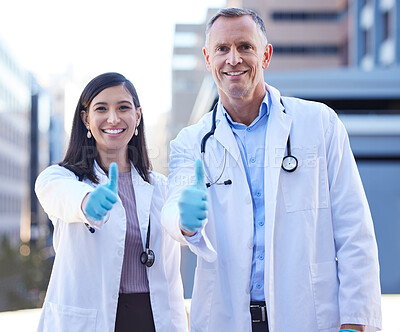 Buy stock photo Doctors, portrait and thumbs up for medical agreement by hospital building, approval or healthcare. Man, woman and face for happy teamwork or wellness support for insurance trust, goals or service