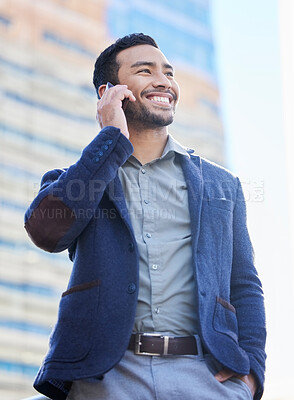 Buy stock photo Shot of a handsome young businessman using a smartphone to make a call