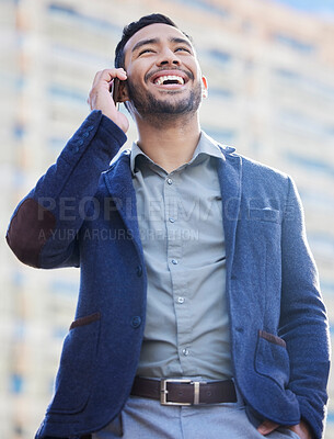 Buy stock photo Shot of a handsome young businessman using a smartphone to make a call