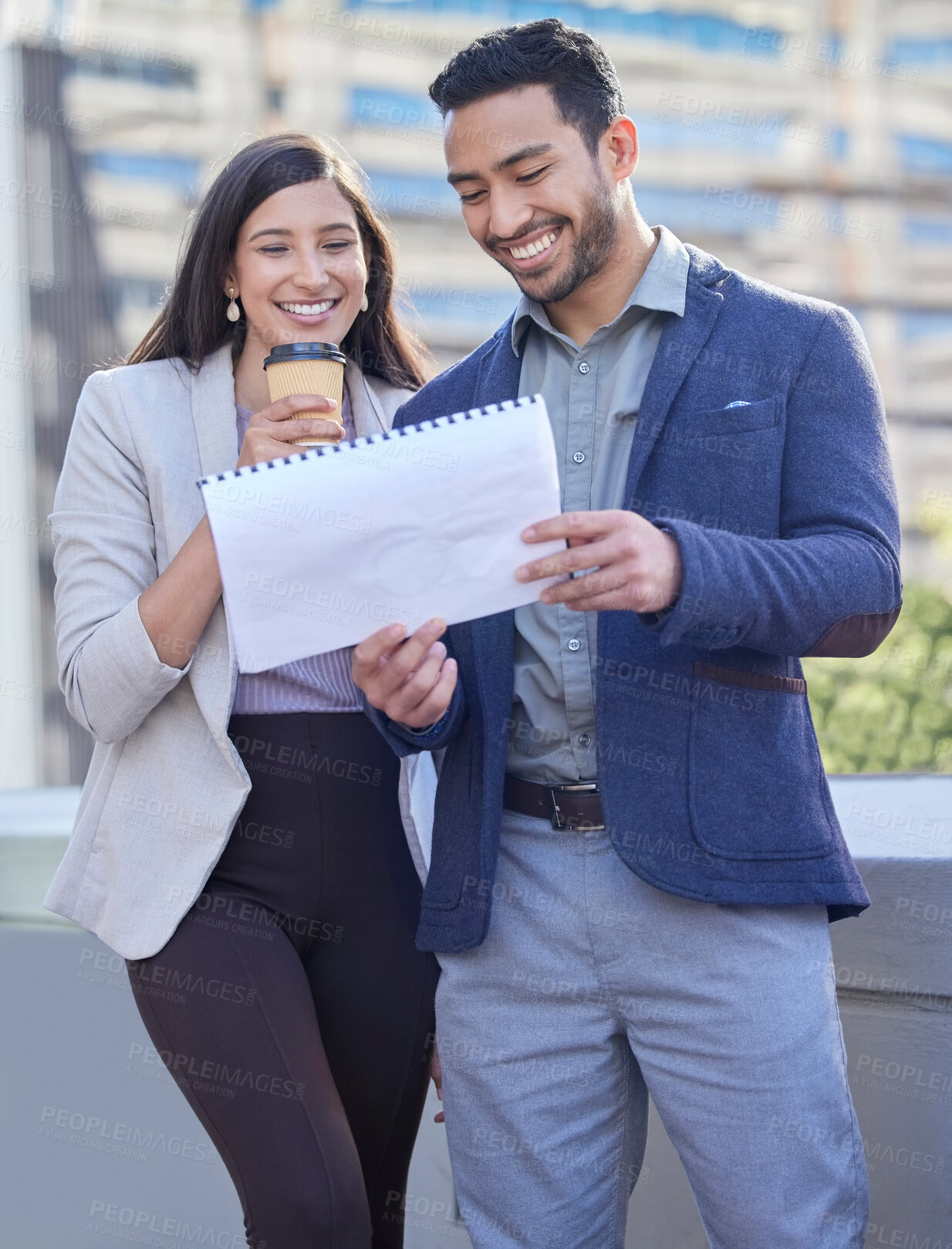 Buy stock photo Shot of two businesspeople reviewing documents together