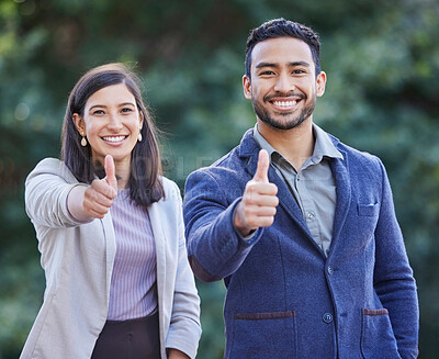 Buy stock photo Shot of two businesspeople giving the thumbs up together