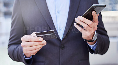 Buy stock photo Shot of a unrecognizable business man shopping on line using his phone outside