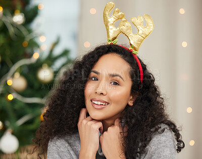 Buy stock photo Portrait of a beautiful young woman wearing a Christmas headband at home