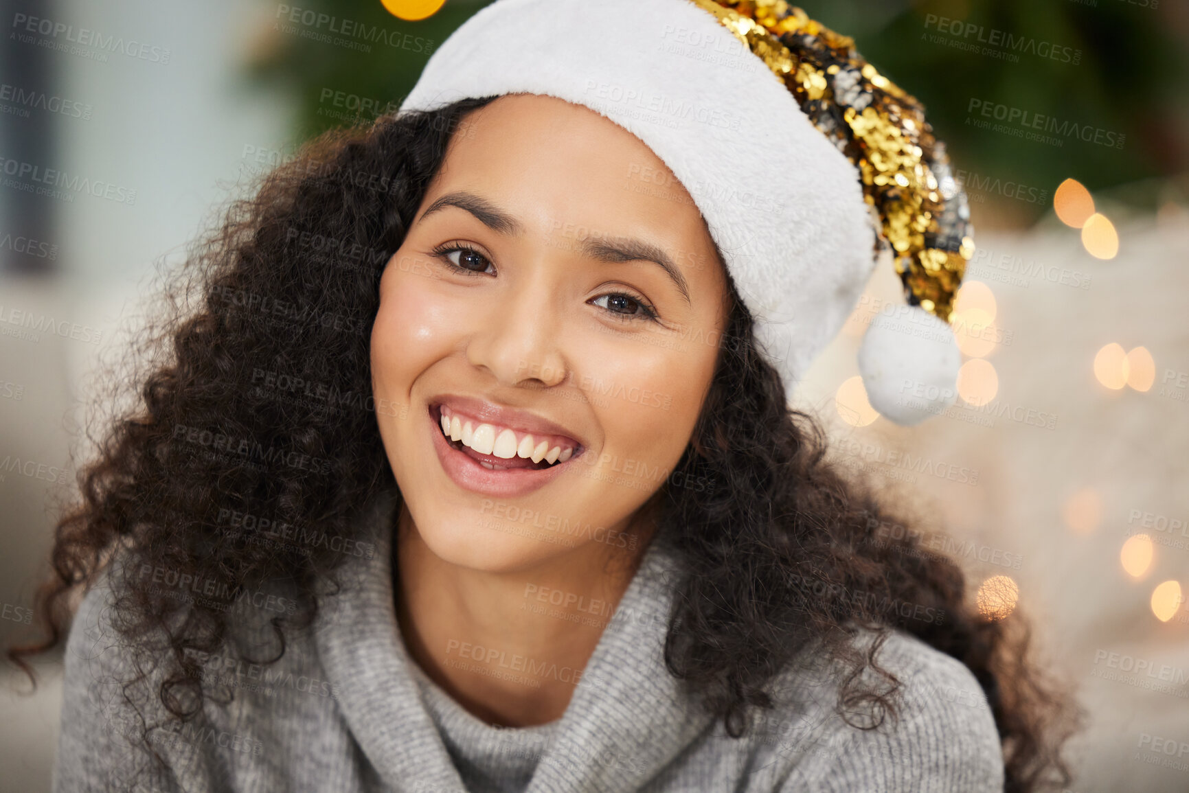 Buy stock photo Portrait of a beautiful young woman wearing a Christmas hat at home