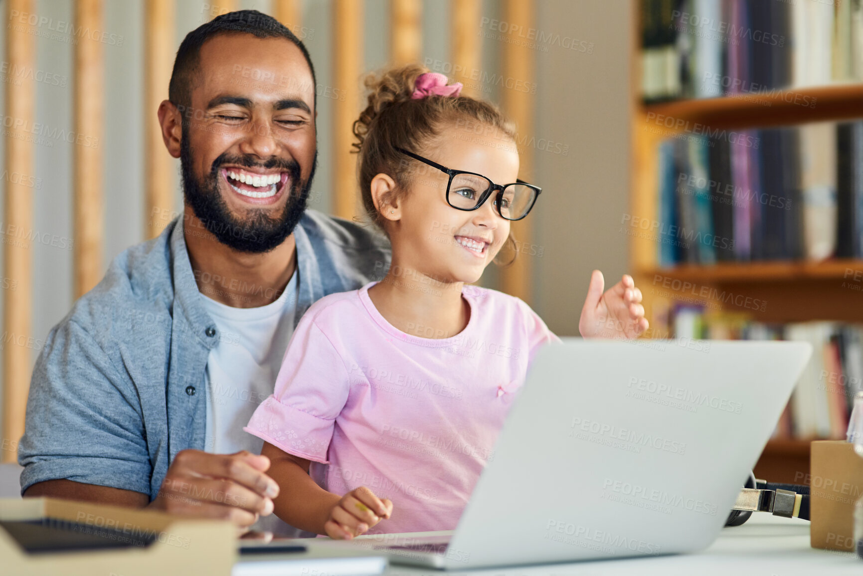 Buy stock photo Shot of a young father showing his daughter his work while playing around with his glasses