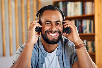 Buy stock photo Shot of a handsome young businessman wearing headphones to listen to music