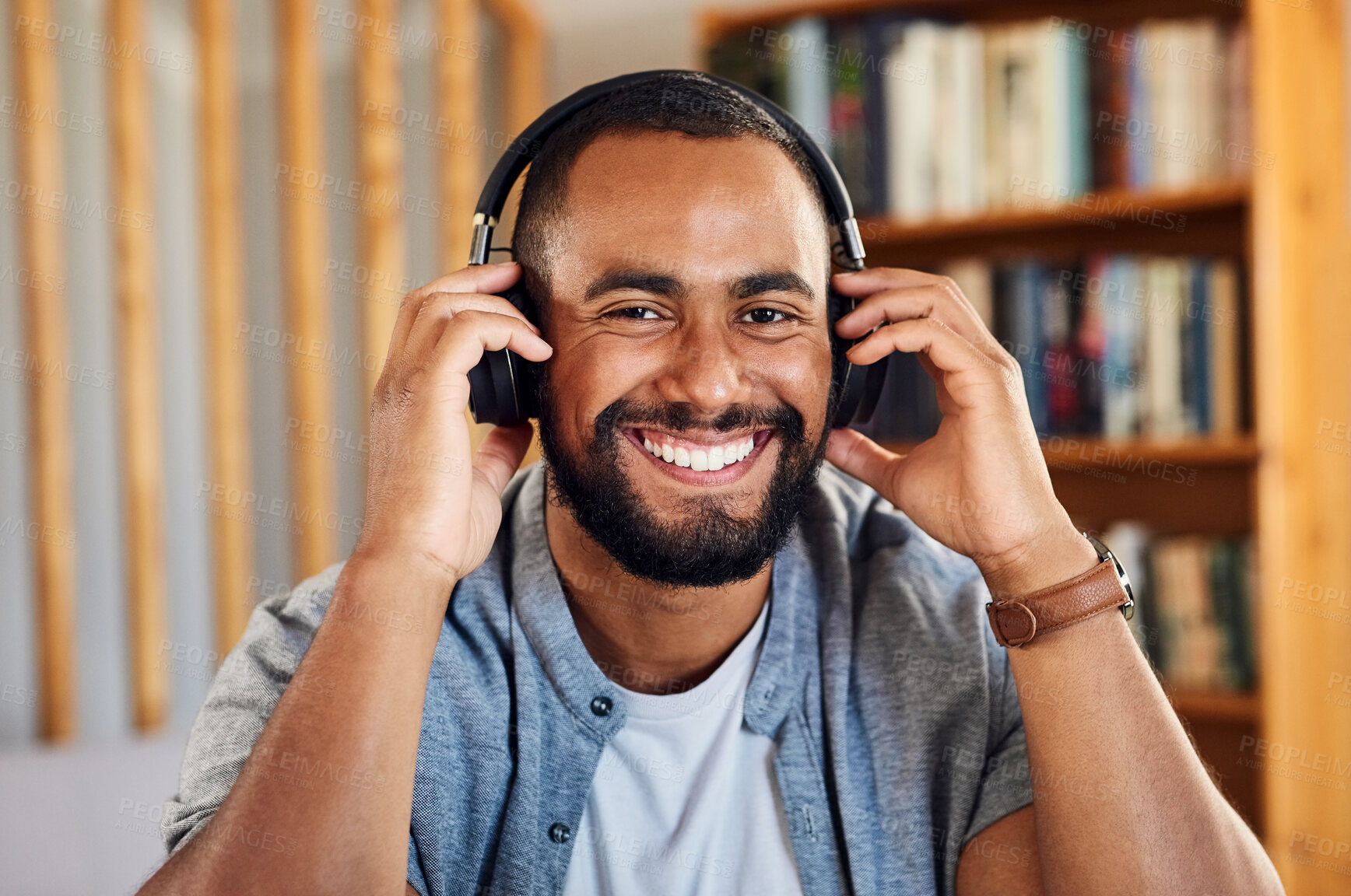 Buy stock photo Shot of a handsome young businessman wearing headphones to listen to music