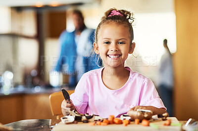 Buy stock photo Shot of an adorable little girl cutting vegetables at home