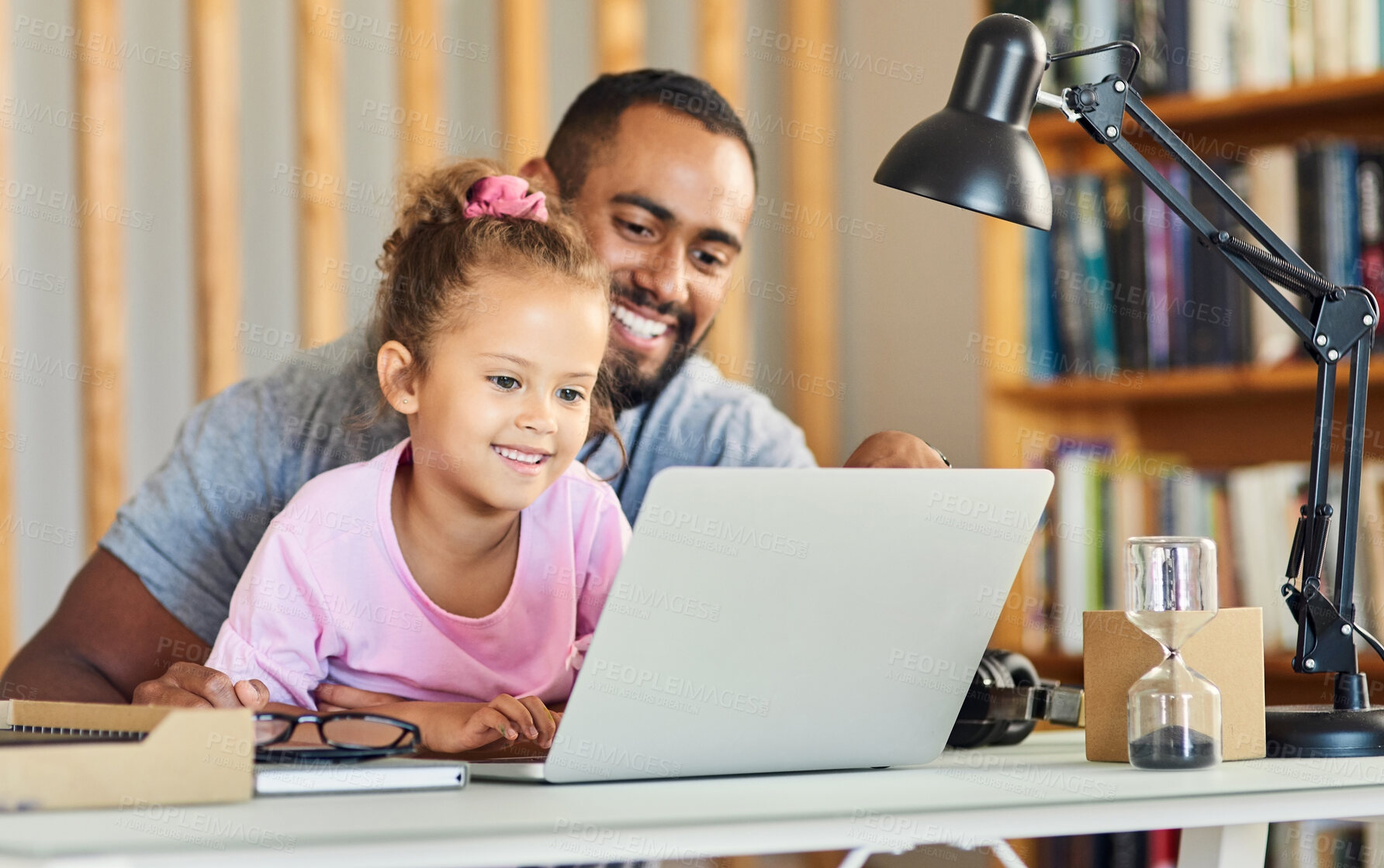 Buy stock photo Shot of a young father showing his daughter his work