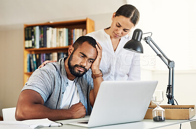 Buy stock photo Shot of a young woman comforting her husband while he works from home