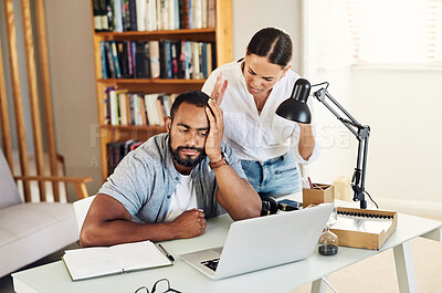 Buy stock photo Shot of a young couple arguing while the husband works from home