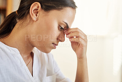 Buy stock photo Shot of a young businesswoman experiencing a headache while working from home