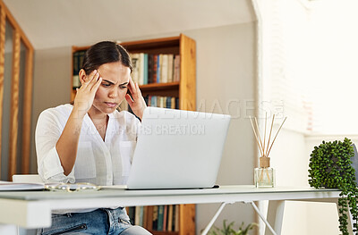 Buy stock photo Shot of a young businesswoman experiencing a headache while working from home