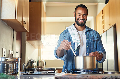 Buy stock photo Shot of a young man cooking at home