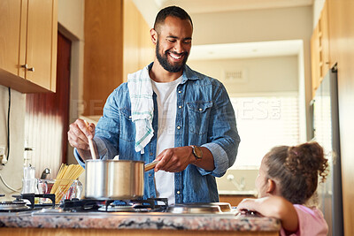 Buy stock photo Shot of a man bonding with his daughter while cooking at home