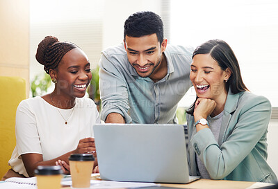 Buy stock photo Cropped shot of a handsome young businessman helping two female colleagues with their laptop while working in the office