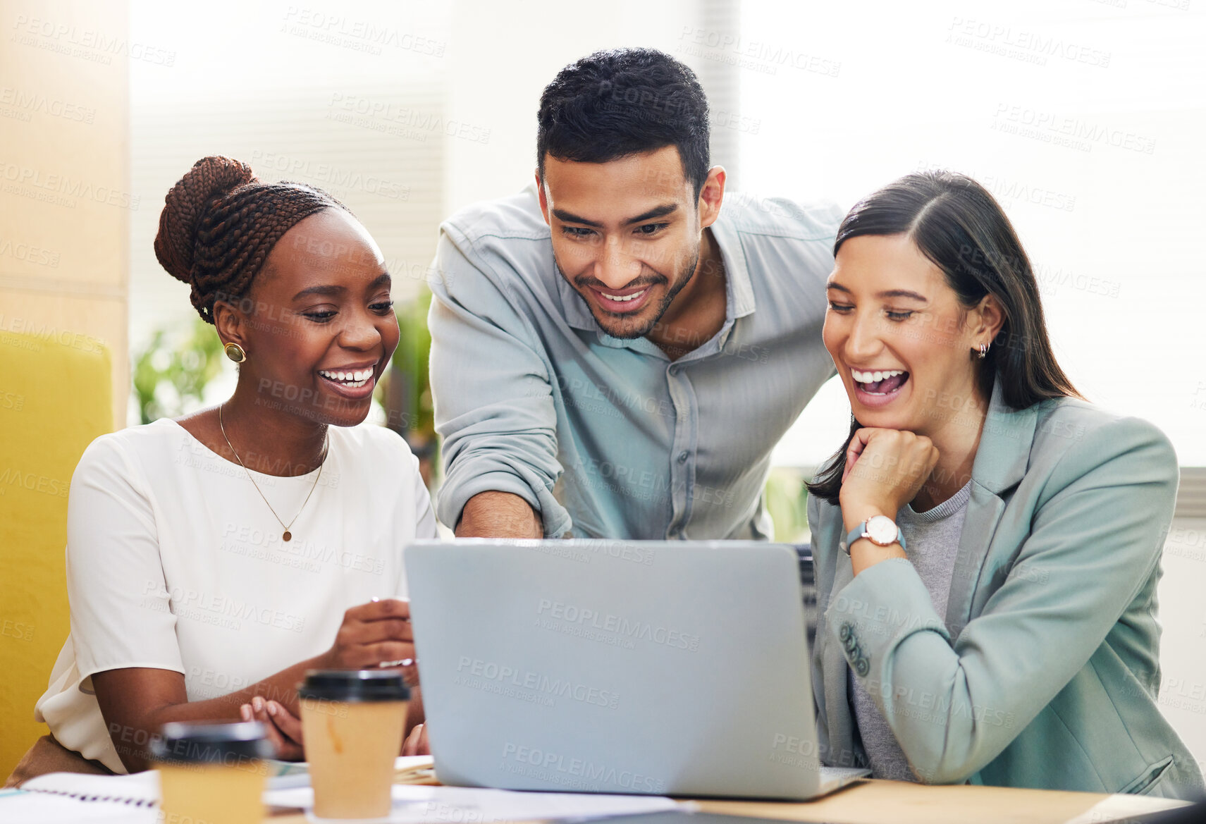 Buy stock photo Cropped shot of a handsome young businessman helping two female colleagues with their laptop while working in the office