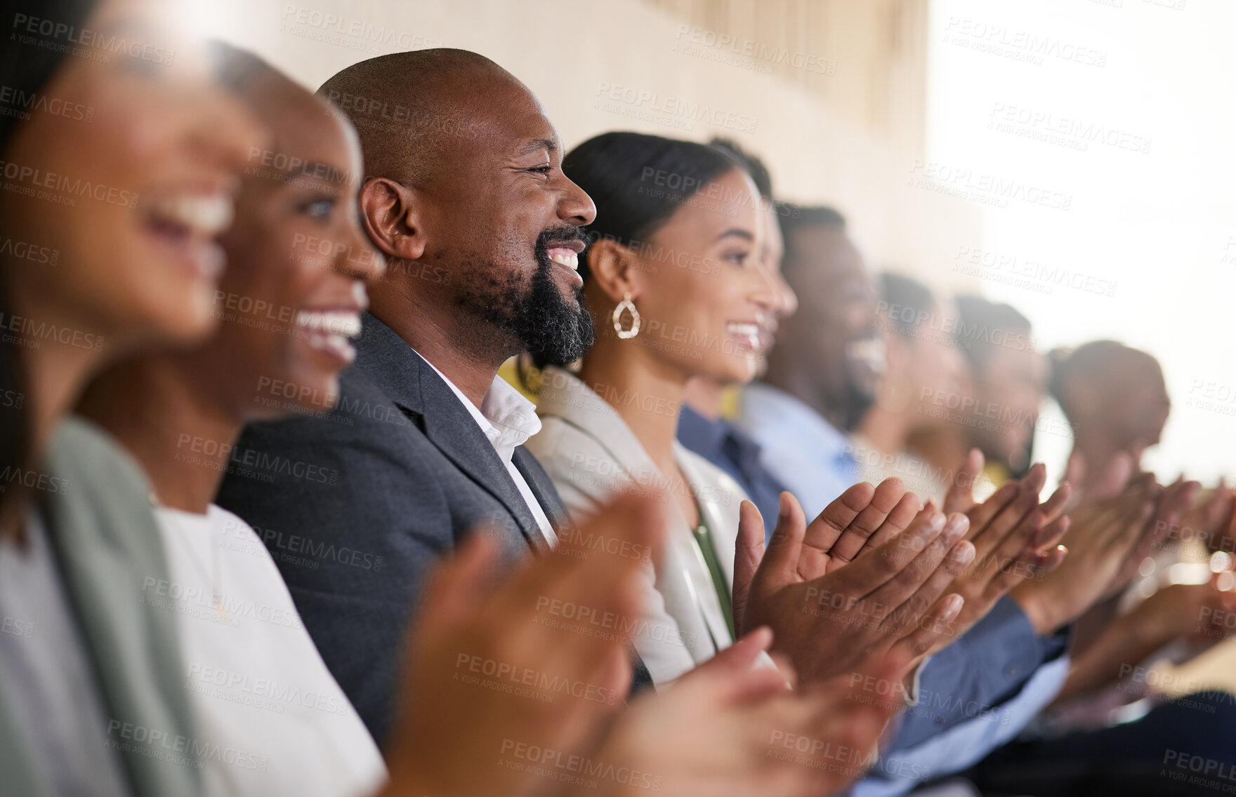 Buy stock photo Cropped shot of a diverse group of businesspeople applauding while sitting in the boardroom during a presentation