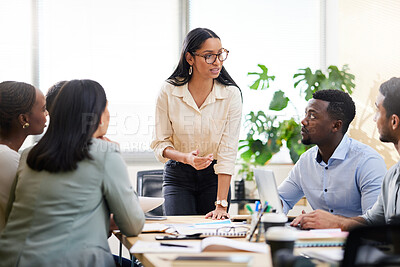 Buy stock photo Cropped shot of an attractive young businesswoman addressing her colleagues during a meeting in the boardroom