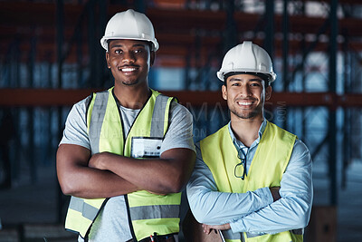 Buy stock photo Shot of two young contractors standing together in the warehouse with their arms crossed