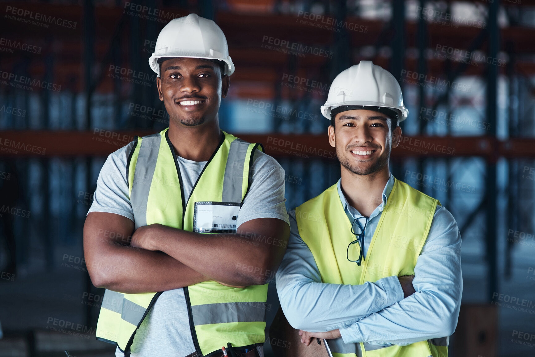 Buy stock photo Shot of two young contractors standing together in the warehouse with their arms crossed