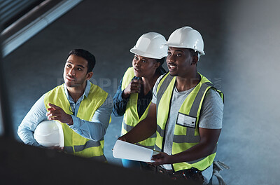 Buy stock photo High angle shot of a group of contractors standing in the warehouse together and having a discussion