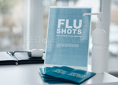 Buy stock photo Shot of a sign, pamphlets and hand sanitiser on a desk in an office