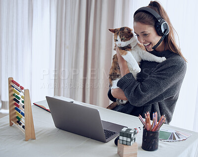 Buy stock photo Shot of a young teacher showing her cat to a student online at home