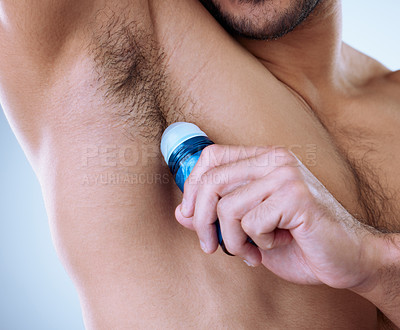 Buy stock photo Cropped studio shot of an unrecognizable man applying deodorant