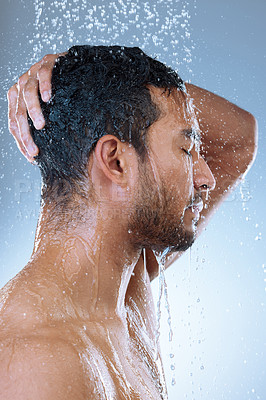 Buy stock photo Studio shot of a handsome young man washing his hair in a shower against a grey background