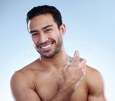 Buy stock photo Studio portrait of a handsome young man applying aftershave
