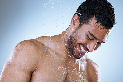Buy stock photo Studio shot of a handsome young man enjoying a shower against a grey background
