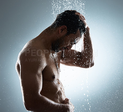 Buy stock photo Studio shot of a young man washing his hair in a shower against a grey background
