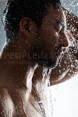 Buy stock photo Studio shot of a young man washing his hair in a shower against a grey background