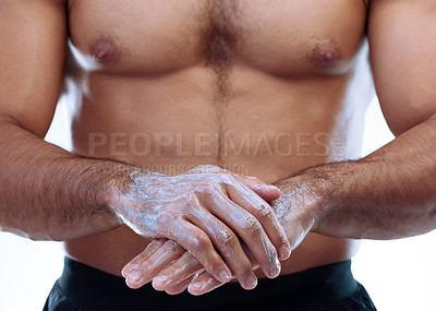 Buy stock photo Closeup shot of an unrecognizable man applying lotion to his skin against a white background