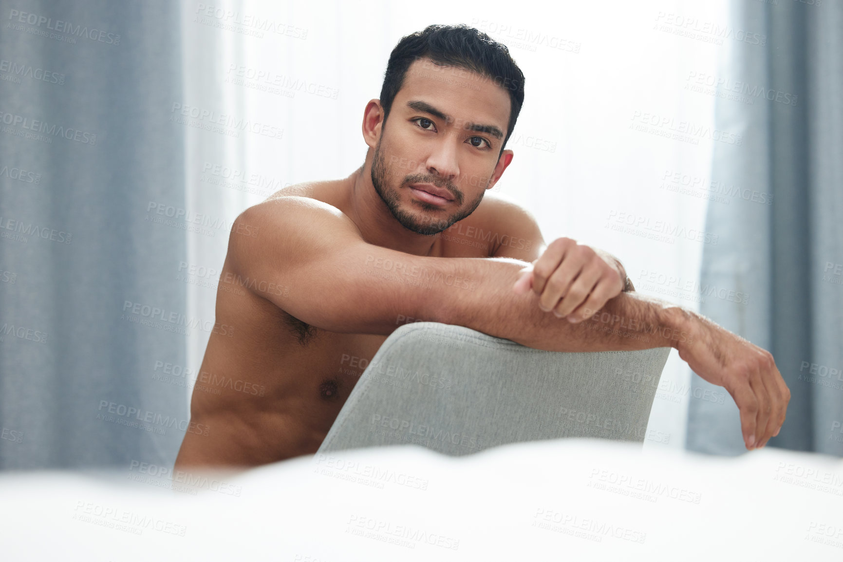 Buy stock photo Nude man, portrait and body on chair with sensual, topless and seductive as hot or alluring in bedroom. Male person, naked and bare for sexy, confidence and masculine with undressed, toned and home