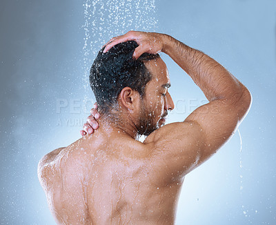 Buy stock photo Rearview studio shot of a handsome young man washing his hair in a shower against a grey background