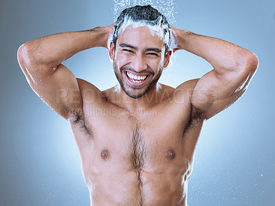 Buy stock photo Portrait shot of a handsome young man enjoying a shower against a grey background