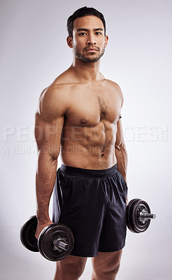 Buy stock photo Shot of a man holding dumb bells against a studio background